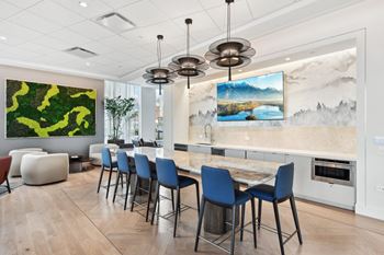 A dining room with a marble table and blue chairs